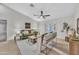 Cozy living room with tile floors, ceiling fan, neutral paint, and bright natural light at 446 W Sereno Dr, Gilbert, AZ 85233