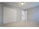 Bedroom with neutral walls, tile floors, closet, and an open doorway to a kitchen at 4719 E Belleview St, Phoenix, AZ 85008