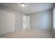 This is a neutral bedroom with tile floors, a large closet, and a kitchen view through the doorway at 4719 E Belleview St, Phoenix, AZ 85008