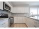 Modern kitchen with stainless steel appliances and white cabinetry at 4719 E Belleview St, Phoenix, AZ 85008
