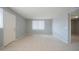 A clean, well-lit living room with tile floors and a white door at 4719 E Belleview St, Phoenix, AZ 85008
