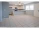 Bright living room with modern tile floors and a partial view of the kitchen at 4719 E Belleview St, Phoenix, AZ 85008