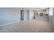 Open-concept living room with tile flooring, a ceiling fan and a view of the kitchen at 4719 E Belleview St, Phoenix, AZ 85008