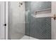 Bathroom featuring a herringbone tile shower with a glass enclosure, and a shower caddy at 501 E 2Nd Ave # 14, Mesa, AZ 85204