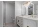 Bathroom featuring a double vanity with gold hardware, white countertops, and decorative mirrors at 501 E 2Nd Ave # 14, Mesa, AZ 85204