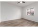 Bright bedroom with neutral flooring, a ceiling fan, and a window with security bars at 501 E 2Nd Ave # 14, Mesa, AZ 85204