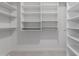 Walk-in closet with white built-in shelving and ample storage space at 501 E 2Nd Ave # 14, Mesa, AZ 85204