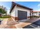 Side view of property, showcasing a private garage and landscaping at 501 E 2Nd Ave # 14, Mesa, AZ 85204