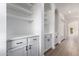 Hallway with built-in white cabinets and drawers, arched entryways and neutral flooring at 501 E 2Nd Ave # 14, Mesa, AZ 85204