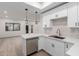 Bright kitchen featuring stainless steel appliances, white cabinets, and an adjacent dining area at 501 E 2Nd Ave # 14, Mesa, AZ 85204