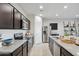 Modern kitchen featuring stainless steel appliances, granite countertops, and island with bar stools at 5758 E Smeaton Pl, San Tan Valley, AZ 85140