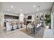 Open concept living area with modern kitchen island seating and adjacent dining space at 5758 E Smeaton Pl, San Tan Valley, AZ 85140