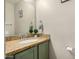 Powder room featuring granite countertop, stylish fixtures, and painted green vanity at 5808 E Brown Rd # 106, Mesa, AZ 85205