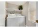 Functional laundry room with washer, dryer, shelf, and a window for natural light at 5808 E Brown Rd # 106, Mesa, AZ 85205