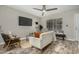 Comfortable living room featuring wood-look tile flooring, a modern ceiling fan, and stylish furnishings at 5808 E Brown Rd # 106, Mesa, AZ 85205