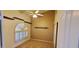 Bright bedroom featuring a ceiling fan, wood shelves, and arched window with adjustable shutters at 6005 E Selkirk Cir, Mesa, AZ 85215