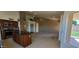 Cozy living room with fireplace, adjacent to kitchen featuring an island and stainless appliances at 6005 E Selkirk Cir, Mesa, AZ 85215