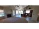 Open floor plan featuring a fireplace, tile flooring, and a kitchen with an island at 6005 E Selkirk Cir, Mesa, AZ 85215