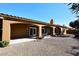Desert landscaped backyard with covered patio featuring table, chairs, potted plants, and desert landscaping at 6323 E Nisbet Rd, Scottsdale, AZ 85254