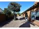 Backyard showcasing desert landscaping, mature tree, and a cozy outdoor living space at 6323 E Nisbet Rd, Scottsdale, AZ 85254