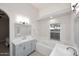 Modern bathroom with double sinks, a soaking tub, and gray cabinetry at 6323 E Nisbet Rd, Scottsdale, AZ 85254