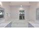 Modern bathroom with double sinks, a soaking tub, and gray cabinetry at 6323 E Nisbet Rd, Scottsdale, AZ 85254