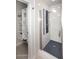 This bathroom features a glass shower with blue tile accents and built-in shelving for towels at 6323 E Nisbet Rd, Scottsdale, AZ 85254