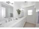Bright bathroom with double sinks, white quartz countertops, and elegant fixtures at 6323 E Nisbet Rd, Scottsdale, AZ 85254