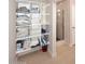 Bathroom shelving next to a glass shower showcases ample storage with many shelves for towels and linens at 6323 E Nisbet Rd, Scottsdale, AZ 85254
