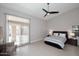 Bedroom featuring a ceiling fan, large windows, and access to the patio at 6323 E Nisbet Rd, Scottsdale, AZ 85254