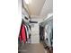 Walk-in closet provides ample storage space with shelving and hanging rods for clothes and accessories at 6323 E Nisbet Rd, Scottsdale, AZ 85254