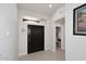 Bright foyer featuring a modern front door, neutral paint, tile flooring, and contemporary finishes at 6323 E Nisbet Rd, Scottsdale, AZ 85254