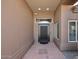Covered entryway featuring a modern front door and a tiled floor, leading into the home at 6323 E Nisbet Rd, Scottsdale, AZ 85254