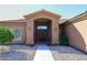 Inviting front entrance with a covered porch and desert landscaping leading to the front door at 6323 E Nisbet Rd, Scottsdale, AZ 85254