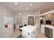Eat-in kitchen featuring an island with seating, stainless appliances, and lots of storage space at 6323 E Nisbet Rd, Scottsdale, AZ 85254