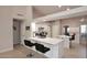 Bright kitchen featuring a large island with bar stool seating and white cabinetry at 6323 E Nisbet Rd, Scottsdale, AZ 85254
