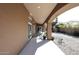 Covered patio features an outdoor seating area with a dining table and desert landscaping at 6323 E Nisbet Rd, Scottsdale, AZ 85254