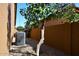 Side yard with rock ground cover and air conditioning unit in a fenced backyard under a clear blue sky at 6323 E Nisbet Rd, Scottsdale, AZ 85254