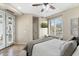 Bright bedroom with a golf course view, ceiling fan, french doors, and built-in window seating at 6340 E Marioca Cir, Scottsdale, AZ 85266