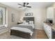 Comfortable bedroom featuring a queen bed, ceiling fan, and wet bar with granite countertops at 6340 E Marioca Cir, Scottsdale, AZ 85266