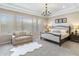 This primary bedroom suite features a sitting area, tray ceiling, large windows, and neutral color palette at 6340 E Marioca Cir, Scottsdale, AZ 85266