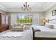 This primary bedroom is bathed in sunlight and features a sitting area and an expansive view to the outdoors at 6340 E Marioca Cir, Scottsdale, AZ 85266