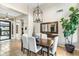 Elegant dining area featuring tile floors, a stylish chandelier, and access to other living spaces at 6340 E Marioca Cir, Scottsdale, AZ 85266