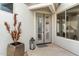 Inviting entryway with double doors, decorative lantern and large potted plant at 6340 E Marioca Cir, Scottsdale, AZ 85266