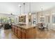 Open-concept kitchen with center island, granite countertops, and seamless flow to living and dining areas at 6340 E Marioca Cir, Scottsdale, AZ 85266