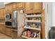 Kitchen detail showcases custom cabinetry and pull-out shelving near stainless steel refrigerator at 6340 E Marioca Cir, Scottsdale, AZ 85266