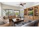Spacious living room with large windows, comfortable seating, and built-in bookshelves at 6340 E Marioca Cir, Scottsdale, AZ 85266