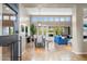 Open-concept living room and dining area featuring high ceilings, large windows, and tile flooring at 6340 E Marioca Cir, Scottsdale, AZ 85266