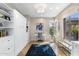 This home office is bright and open and features generous natural light, white built-ins and a cozy desk at 6340 E Marioca Cir, Scottsdale, AZ 85266
