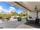 Covered patio features a built-in grill, dining area, and relaxing hot tub, perfect for outdoor enjoyment at 6340 E Marioca Cir, Scottsdale, AZ 85266